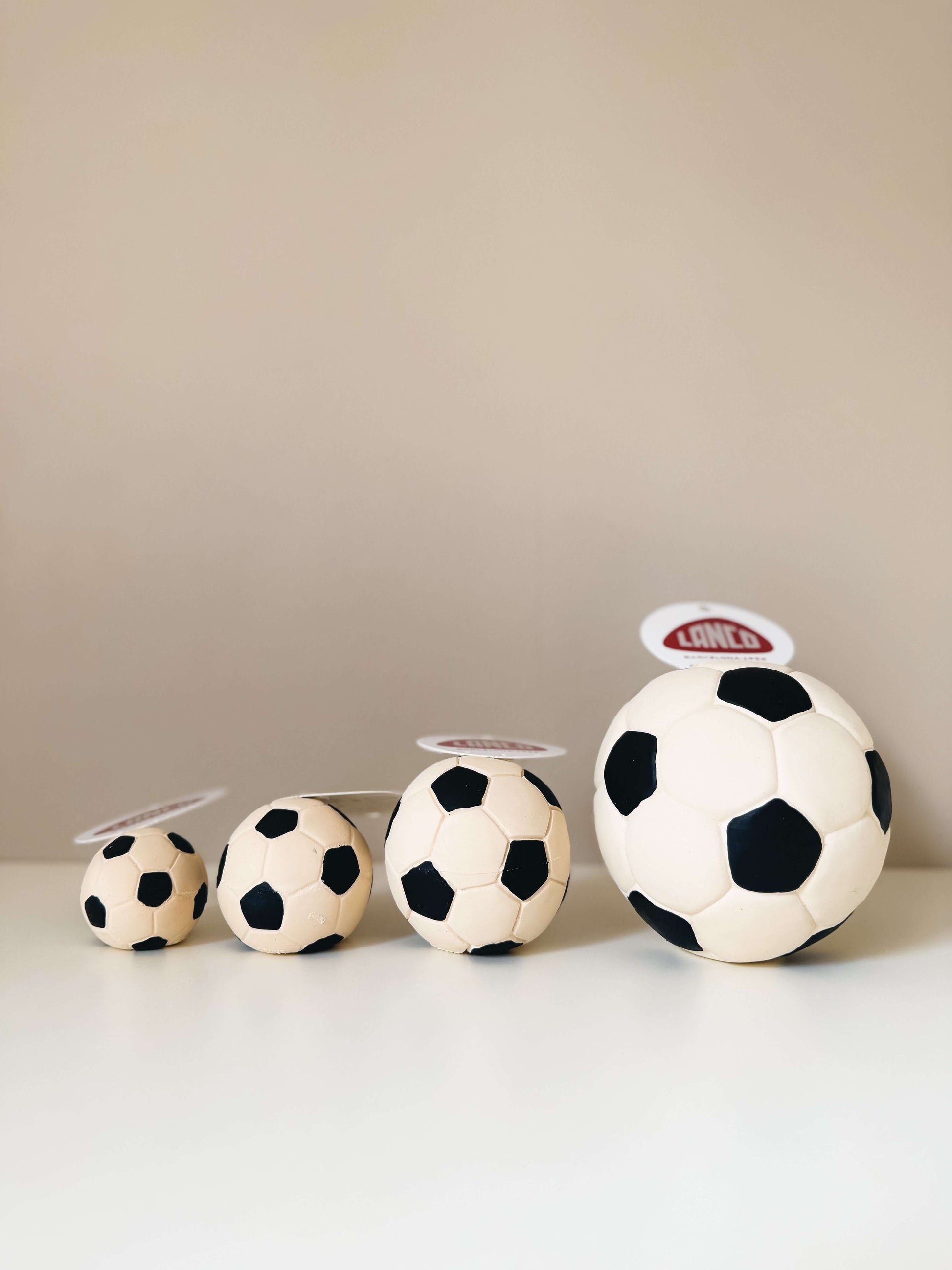 LANCO｜ランコ【サッカーボール】 in various sizes arranged on a table, showcasing the colorful design and quality.