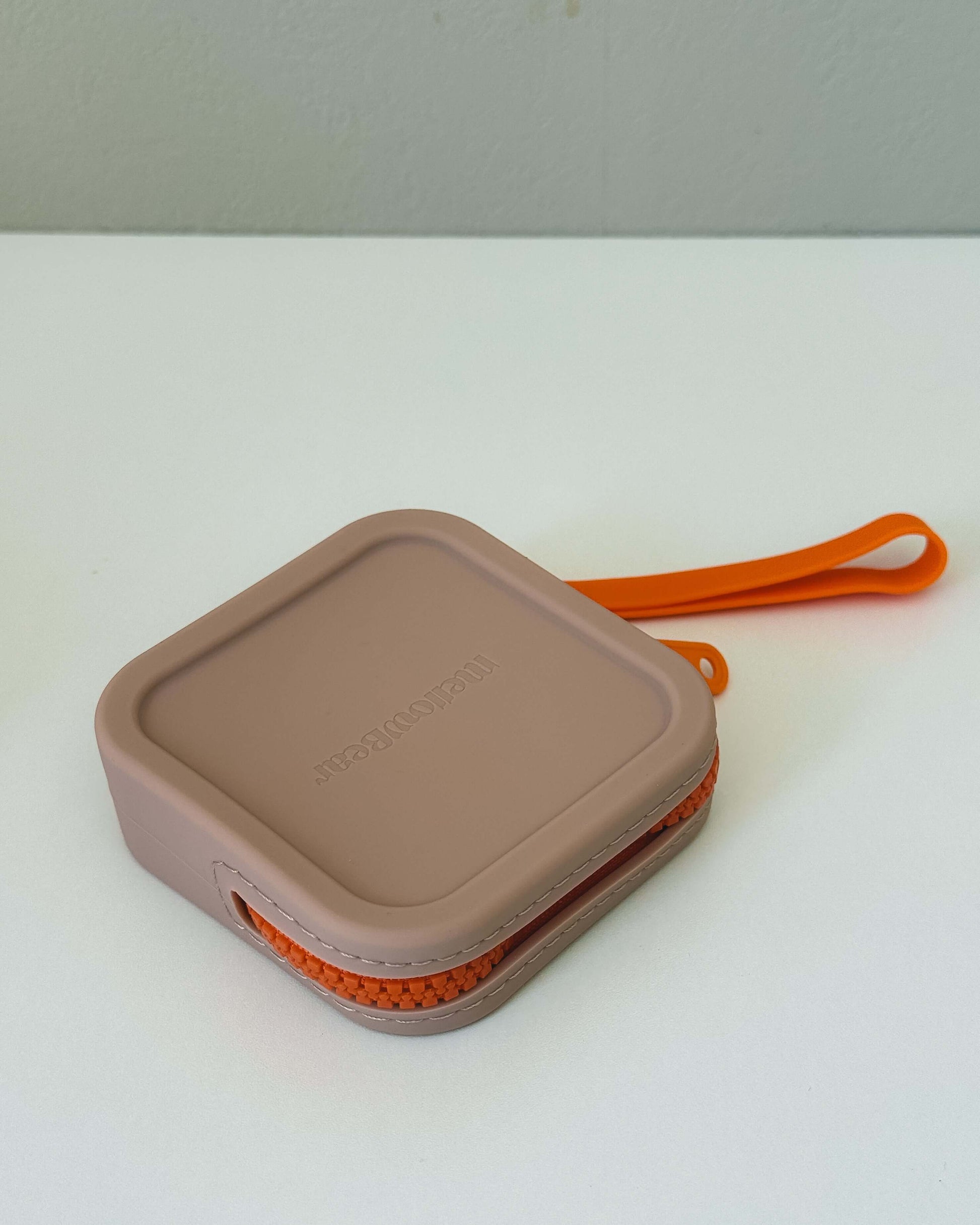mellowbear【Washable Treats holder】 in soft beige silicone with orange zipper, perfect for holding snacks.